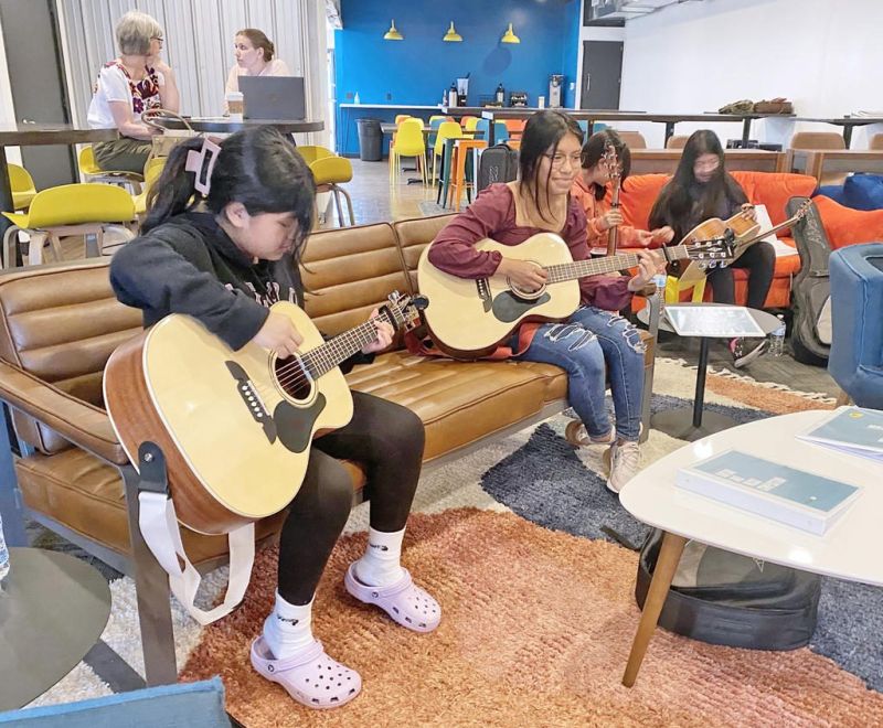 Adelante Arts Camp students learn to play guitar