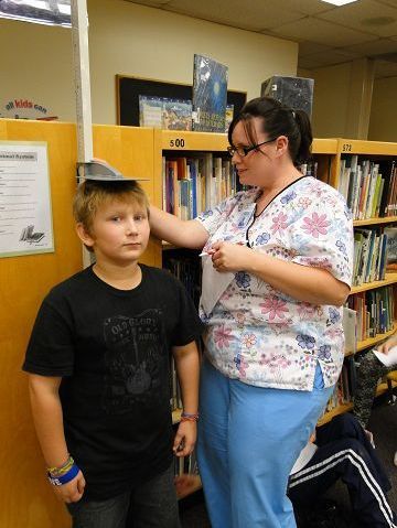 Adult practical nursing students assist with screenings