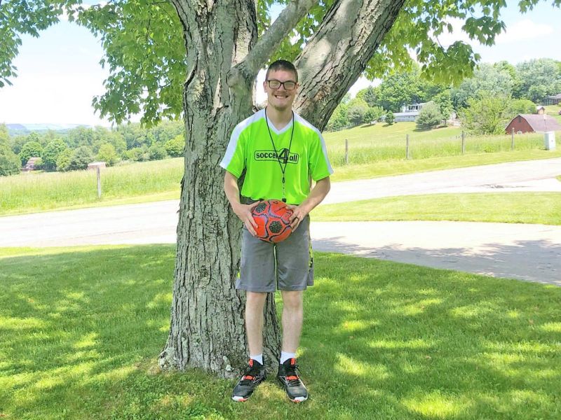 Bolivar man has a ball coaching at Soccer4All