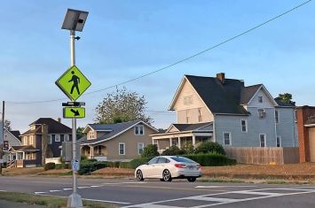 Caution lights are in operation at the crosswalk