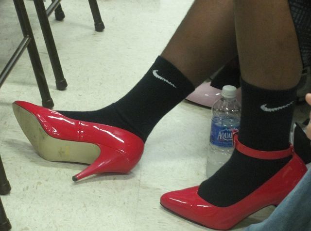 Football team volunteers to walk a mile in womens shoes to raise awareness about violence against women