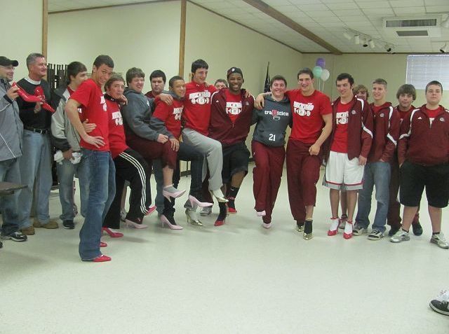 Football team volunteers to walk a mile in womens shoes to raise awareness about violence against women