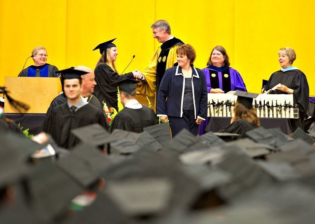 Happy grads cross the stage at rainy College of Wooster commencement