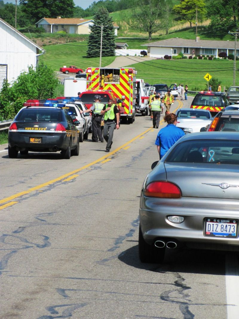 Motorcyclist collides with pickup truck; numerous emergency personnel assist at the scene