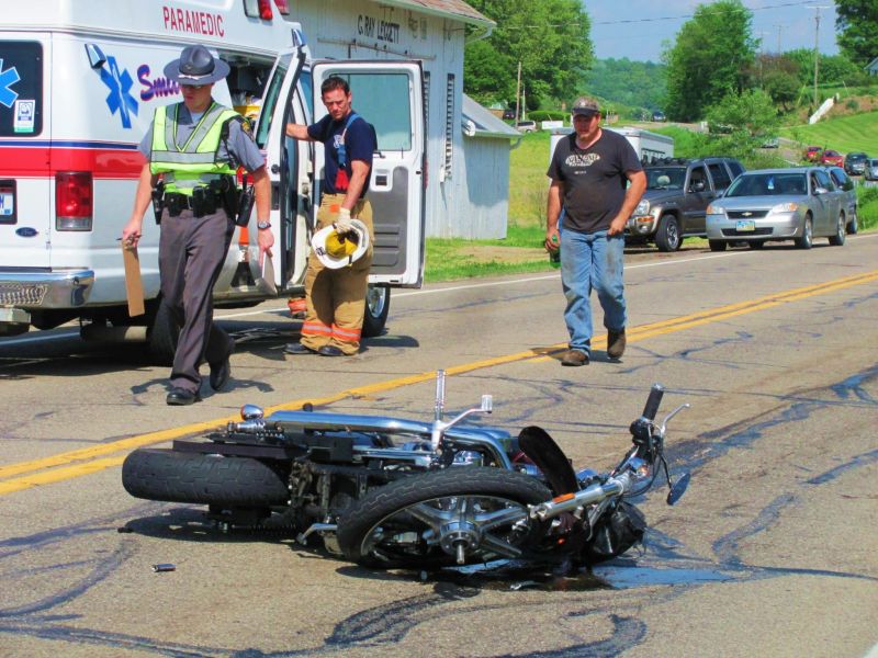 Motorcyclists collision with pickup truck results in fatality; numerous emergency personnel assist at the scene