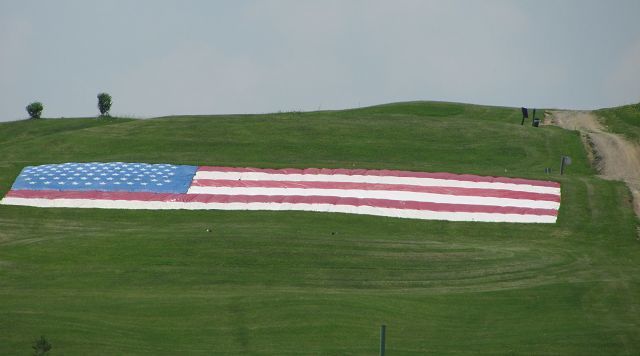 Old Glory overlooks green as veterans are honored at golfing event