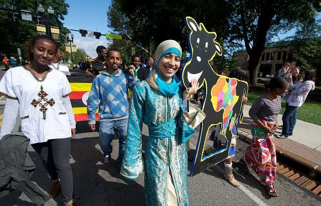 Student groups and others walk in COW Homecoming Parade