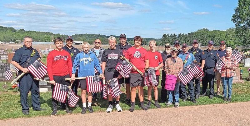 Volunteers place flags